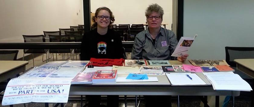 Nancy and Phebe seated at a table with an assortment of archival materials laid out.